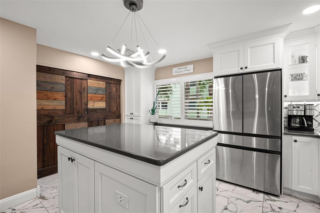 529 Sandy Hook Road Treasure Island, FL 33706 - Photo 18 of 55 a kitchen with stainless steel appliances granite countertop a refrigerator a sink and dishwasher