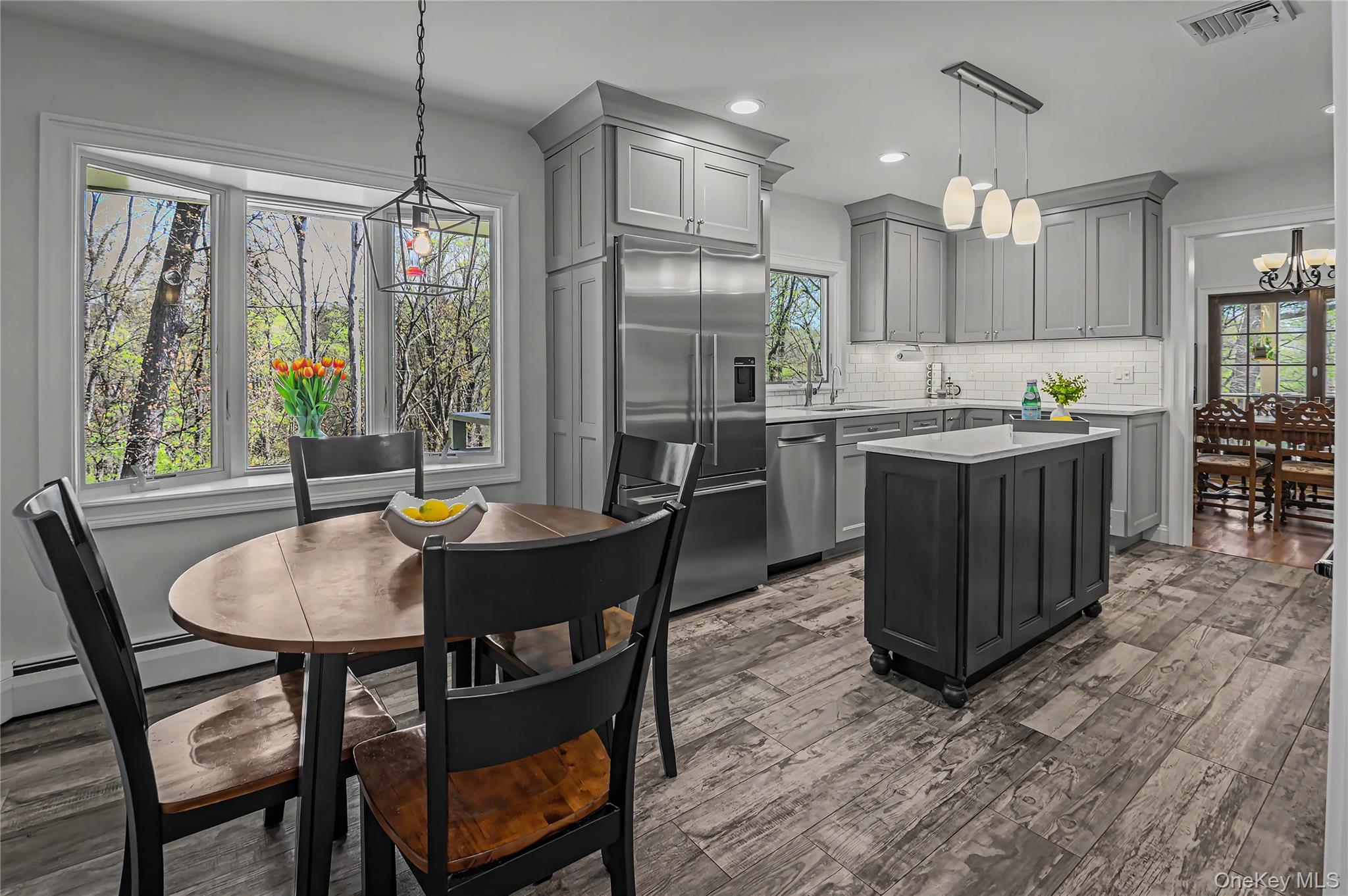 41 Cross Pond Road Pound Ridge, NY 10576 - Photo 10 of 41 a kitchen with kitchen island a dining table chairs and refrigerator