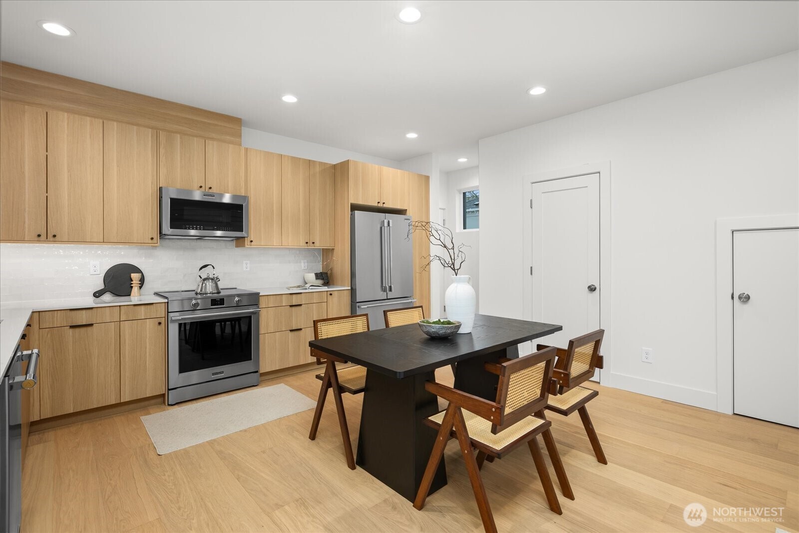 3407 Northwest 57th Street Seattle, WA 98107 - Photo 11 of 29 a kitchen with a stove a sink a microwave a counter top space and cabinets