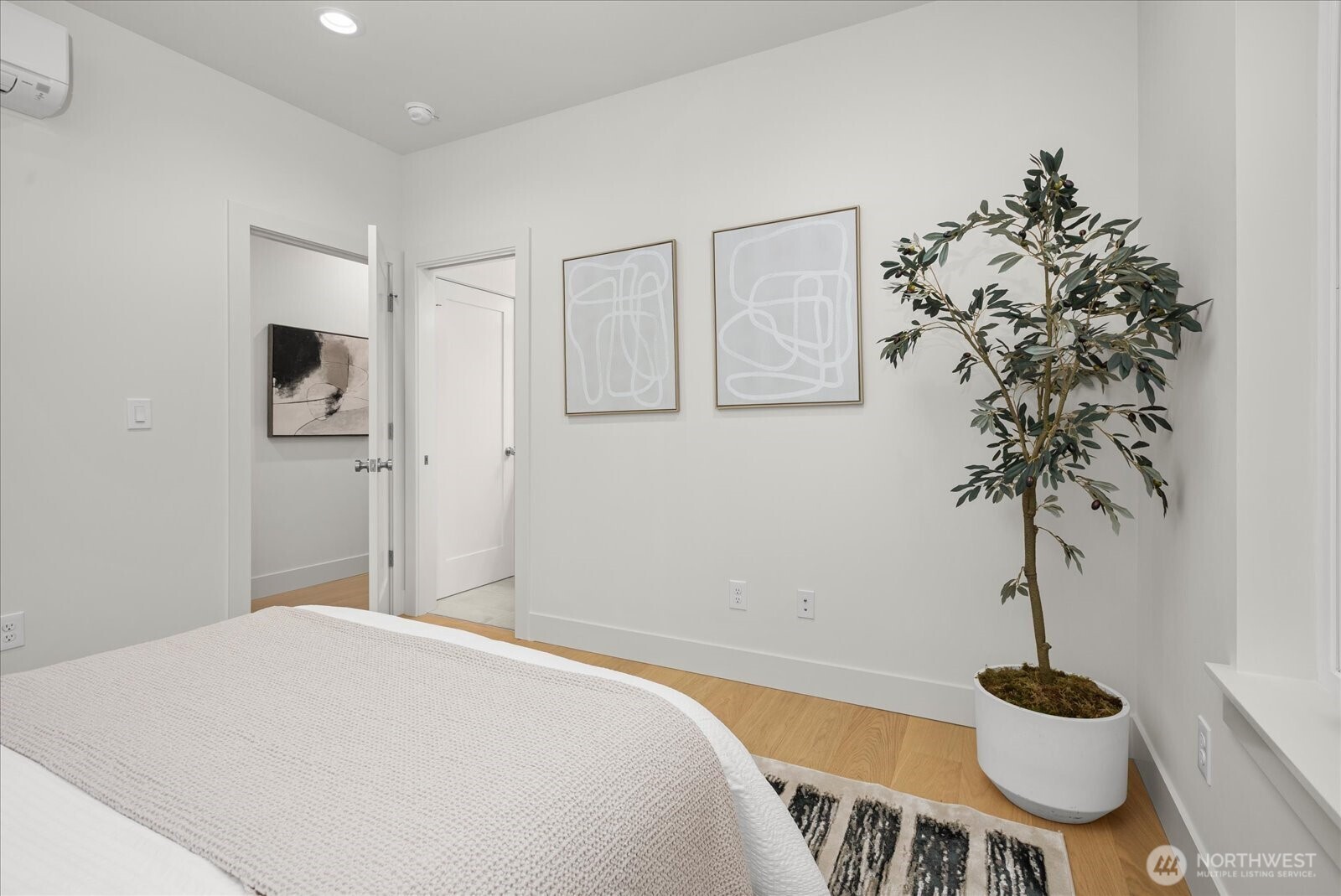 3407 Northwest 57th Street Seattle, WA 98107 - Photo 16 of 29 a bedroom with a bed and a potted plant