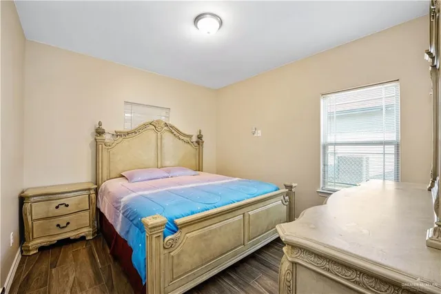 a bedroom with a bed and a tv