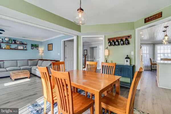a view of a dining room with furniture wooden floor and chandelier