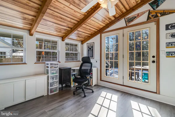 a workspace with furniture wooden floor and windows