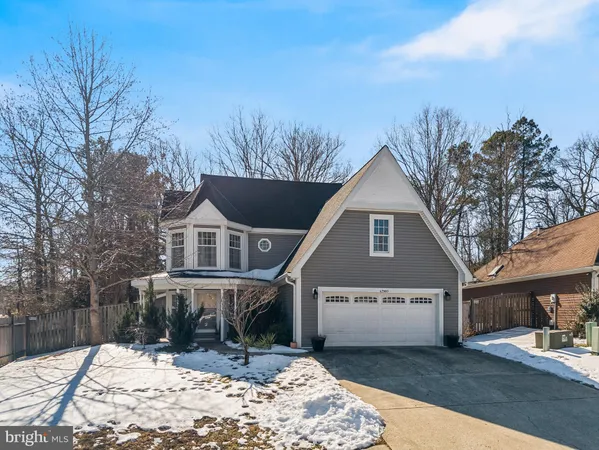 a view of a house with a yard covered in snow
