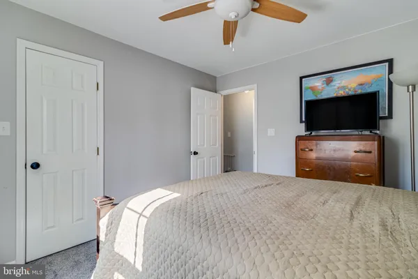 a bedroom with a bed and flat screen tv