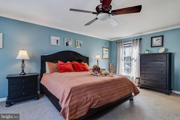 a bedroom with a bed and a night stand