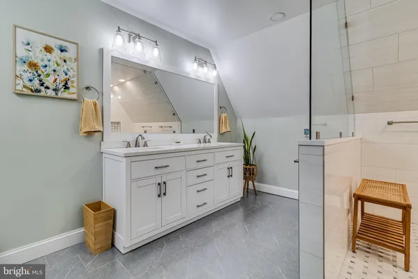 a bathroom with a double vanity sink and a mirror