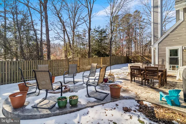 a view of a patio with a dining table and chairs