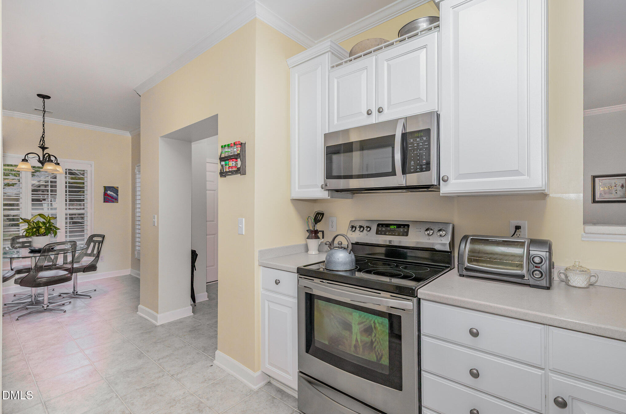 2541 Forest Shadows Lane Raleigh, NC 27614 - Photo 5 of 23 a kitchen with granite countertop a stove a microwave a refrigerator a cabinets and potted plant