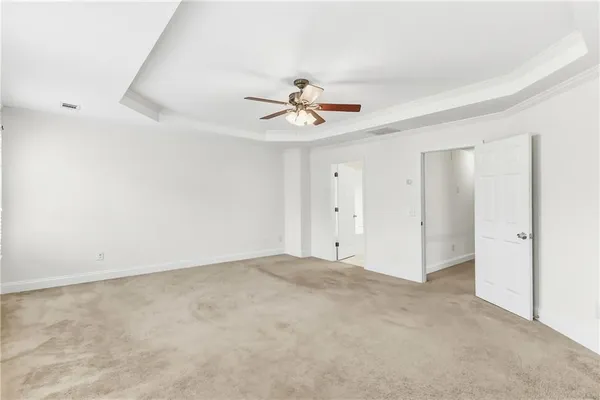 a view of a room with a ceiling fan and a window