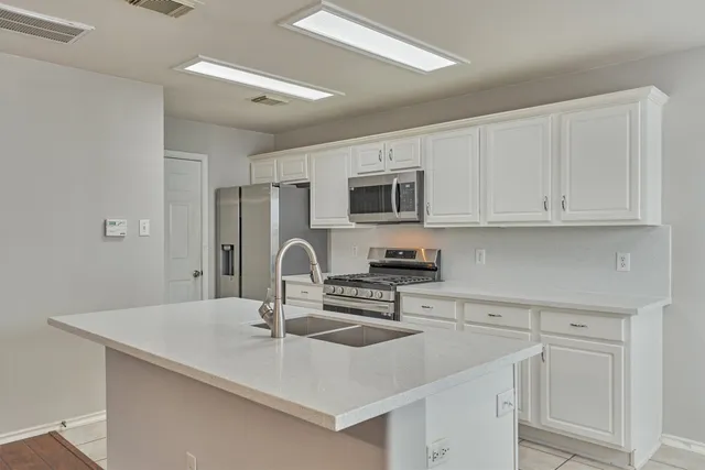 a kitchen with a sink stove and cabinets