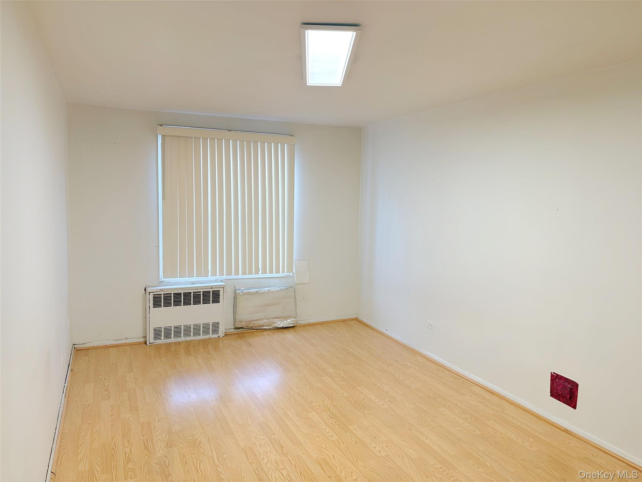 152-72 Melbourne Avenue, Unit 1D Queens, NY 11367 - Photo 7 of 14 an empty room with a window