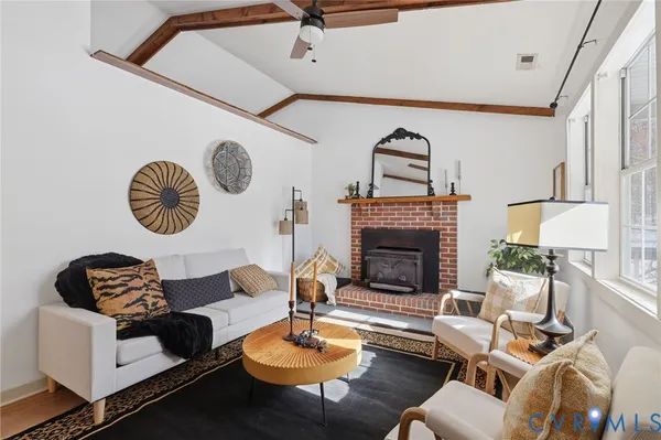 a living room with furniture a rug and a fireplace