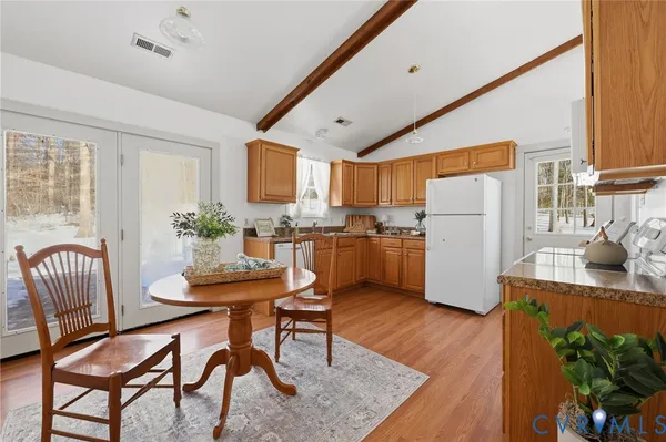a dining room with furniture and wooden floor