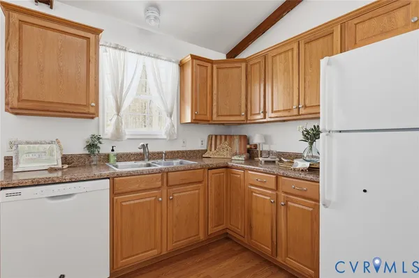 a kitchen with granite countertop a sink stove and refrigerator