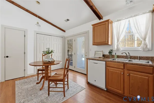 a kitchen with sink cabinets and wooden floor