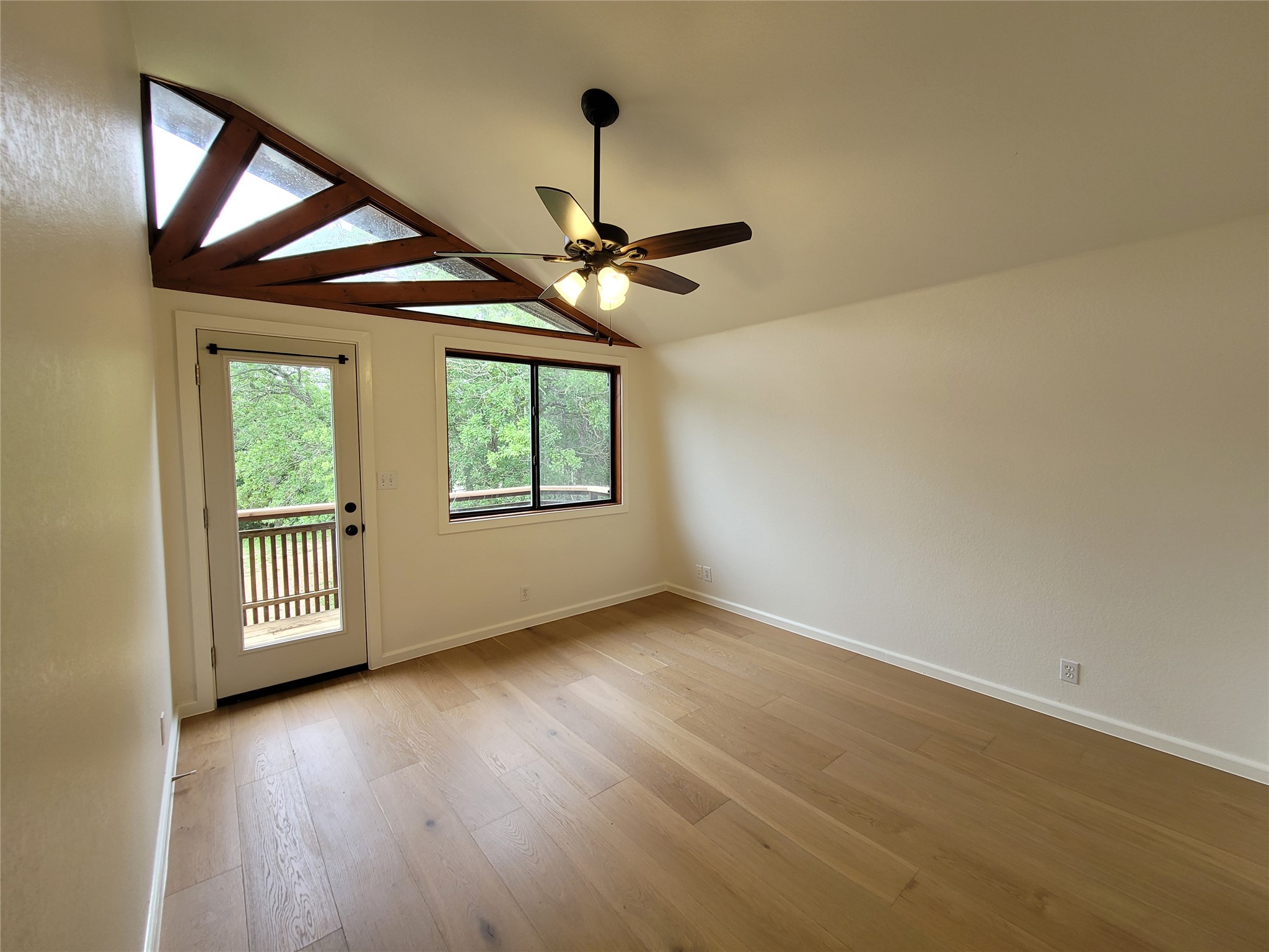 281 Earl Callahan Road, Unit A Cedar Creek, TX 78612 - Photo 26 of 39 an empty room with wooden floor chandelier and windows
