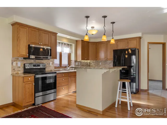 a kitchen with kitchen island granite countertop a stove and a sink