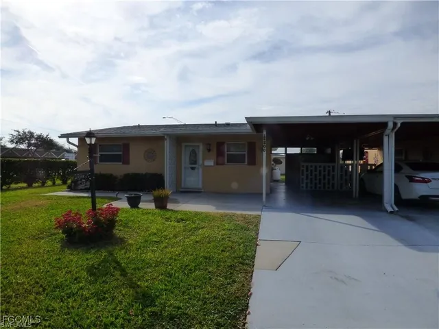 a view of a house with backyard sitting area and garden