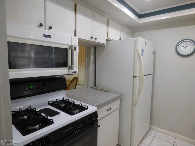 a kitchen with a stove and a refrigerator