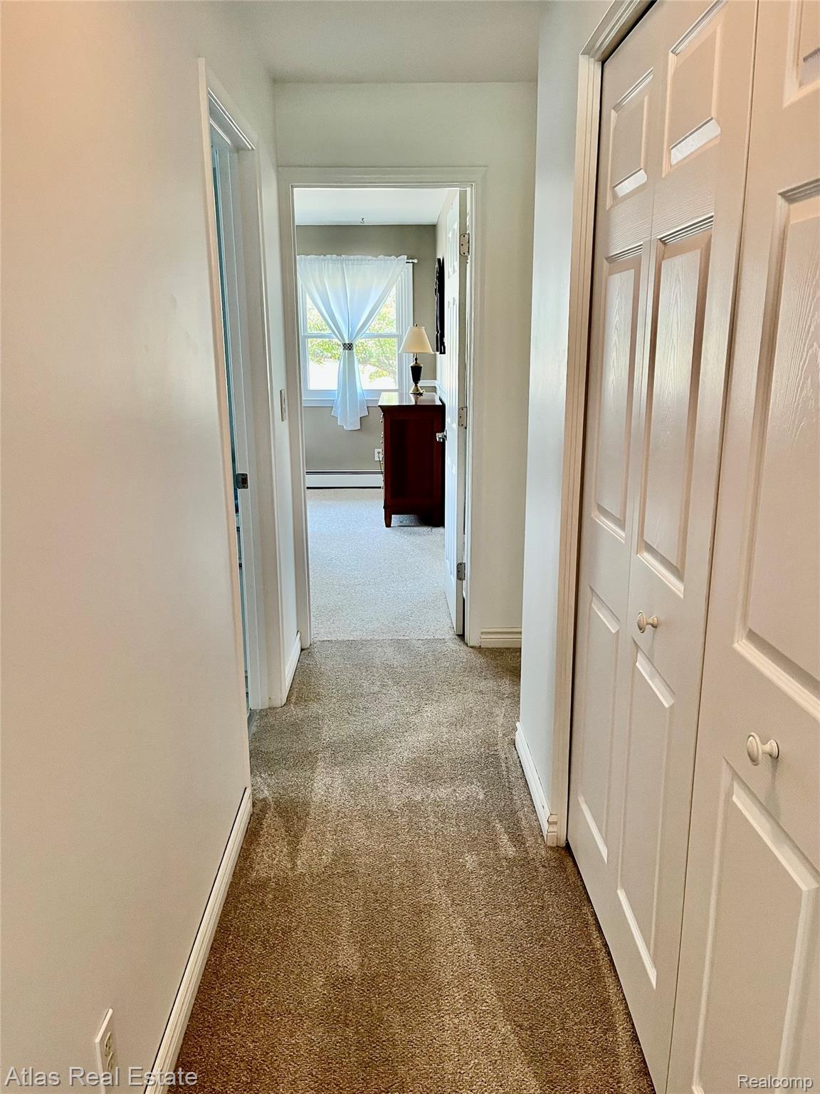 12026 Coolidge Road Goodrich, MI 48438 - Photo 39 of 56 Carpeted hallway with white walls and bi-fold doors