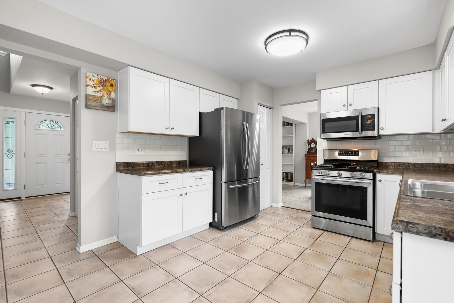 596 Buckboard Road Bolingbrook, IL 60490 - Photo 11 of 30 a kitchen with granite countertop a refrigerator and a stove top oven