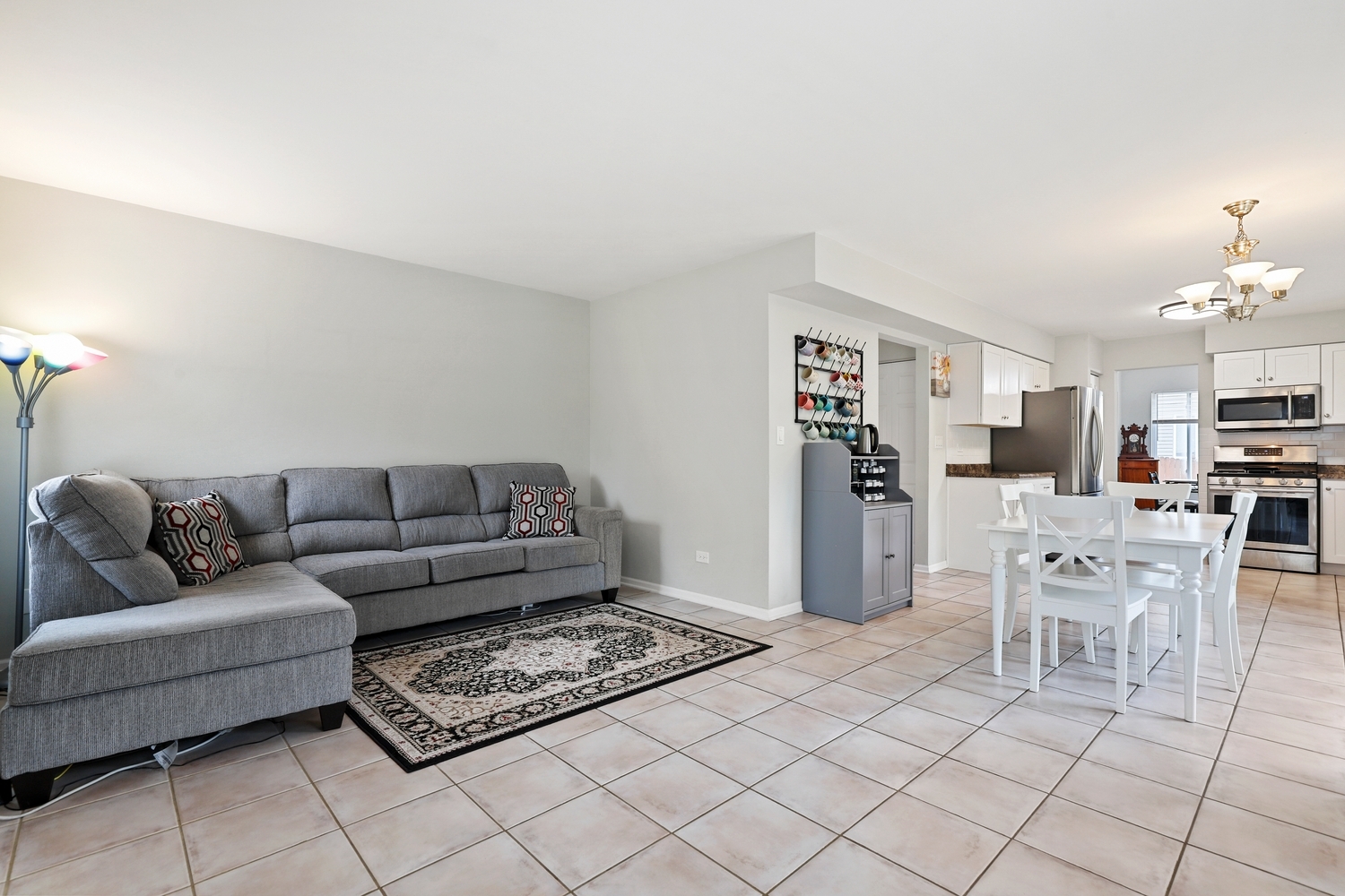 596 Buckboard Road Bolingbrook, IL 60490 - Photo 16 of 30 a living room with furniture and a dining table with kitchen view