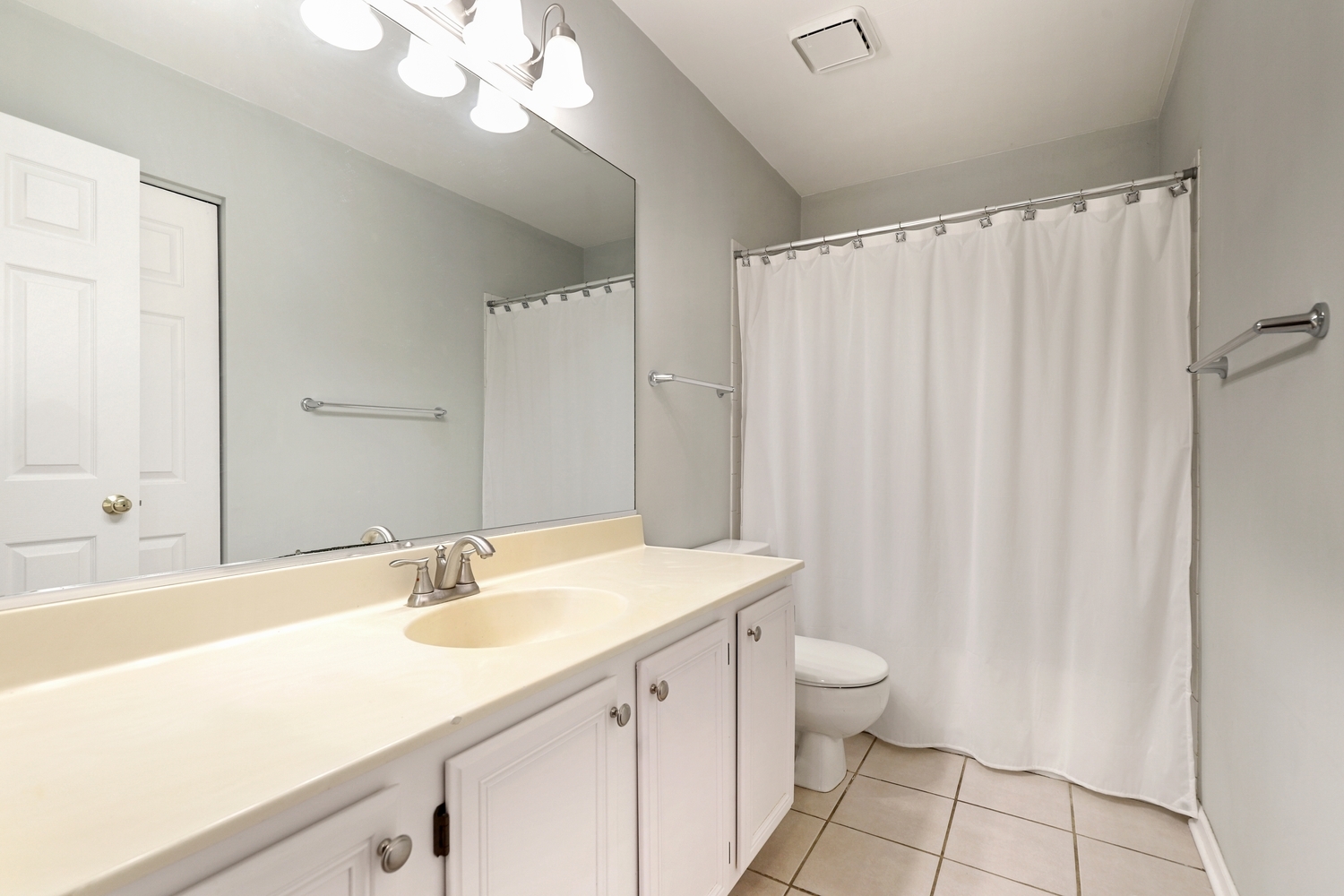 596 Buckboard Road Bolingbrook, IL 60490 - Photo 25 of 30 a bathroom with a sink a toilet and a large mirror