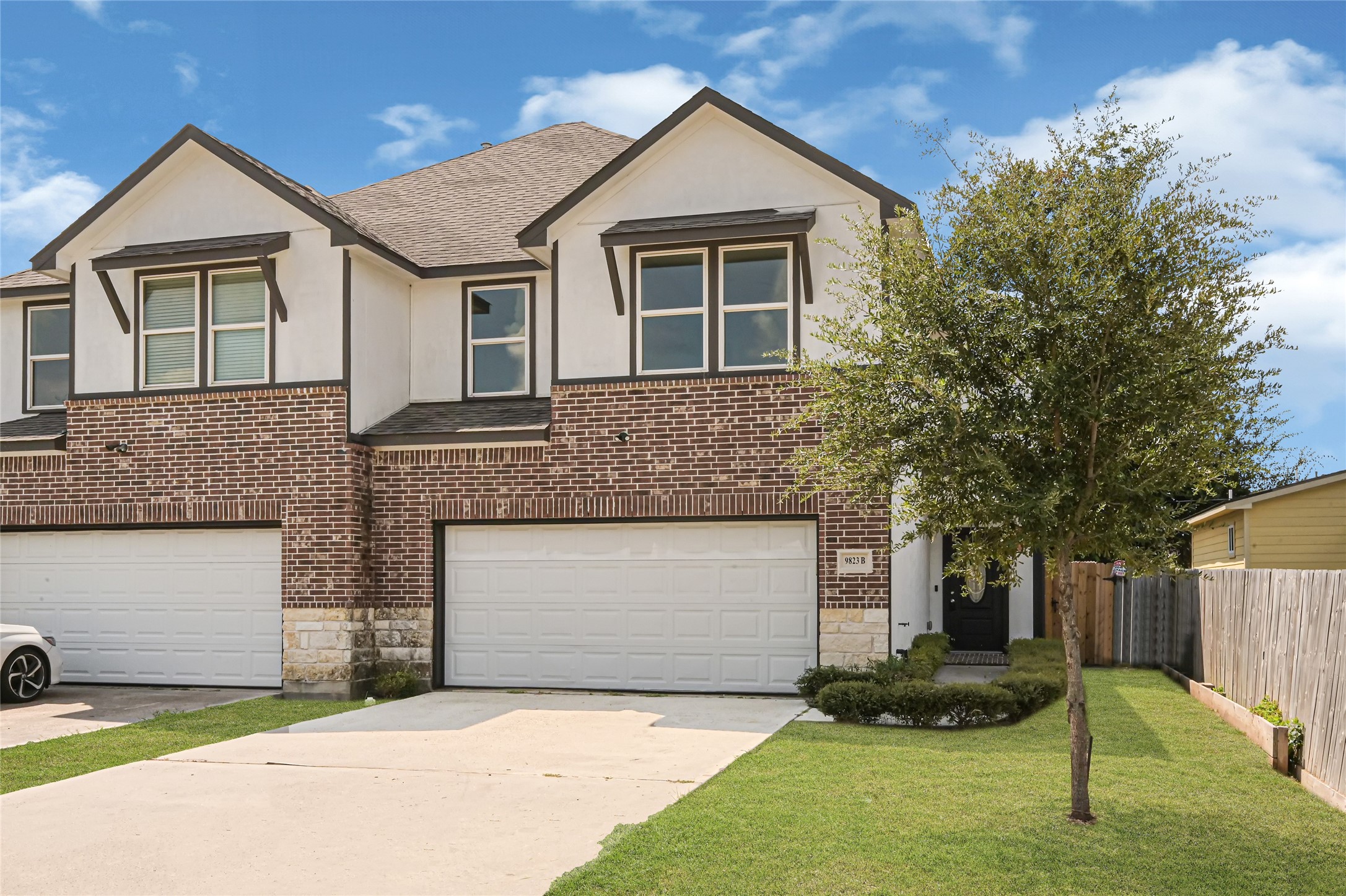 9823 Bamboo Road, Unit B Houston, TX 77041 - Photo 3 of 33 Additional view of the home's brick facade, driveway, and established landscaping.