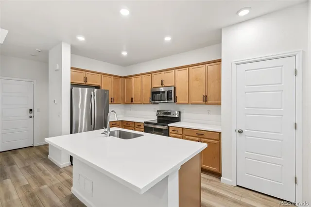a kitchen with stainless steel appliances a stove a refrigerator and cabinets