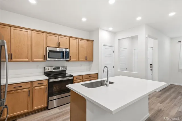 a kitchen that has a sink and a stove top oven