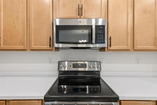 a kitchen with a stove and a microwave
