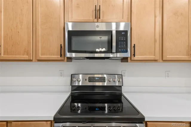 a kitchen with a stove and a microwave