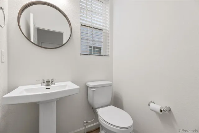 a bathroom with a toilet and a sink