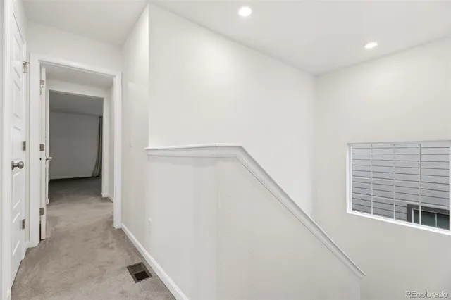 a view of a hallway with a closet and a window