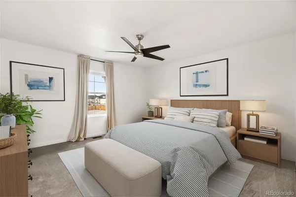 a bedroom with a large bed and a chandelier