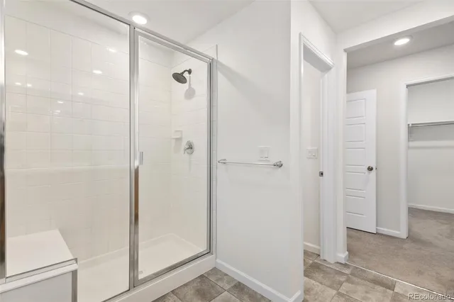 a bathroom with a shower and a glass door