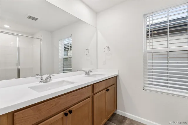 a bathroom with a sink double vanity and a mirror