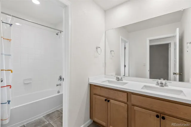 a bathroom with a tub sink and mirror