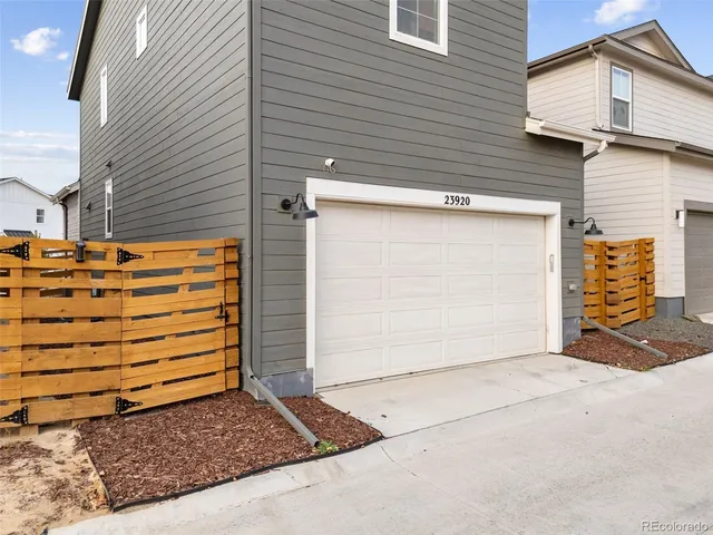 a view of a house with a door and wooden bench