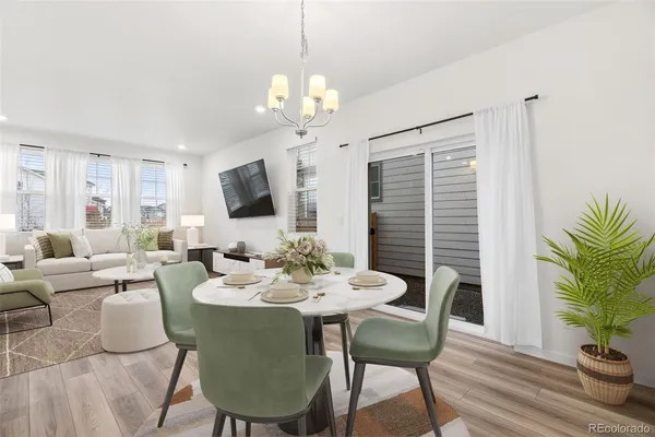 a view of a dining room with furniture window and wooden floor