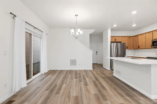 a view of kitchen with granite countertop cabinets and wooden floor