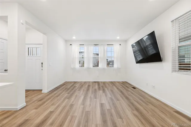 wooden floor in an empty room with a window
