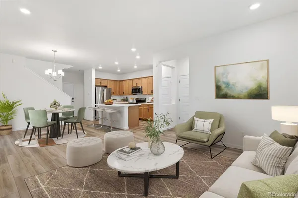 a living room with furniture kitchen view and a dining table