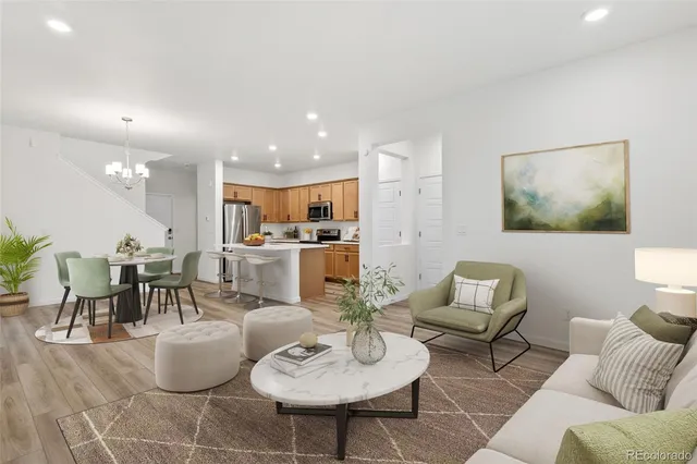 a living room with furniture kitchen view and a dining table
