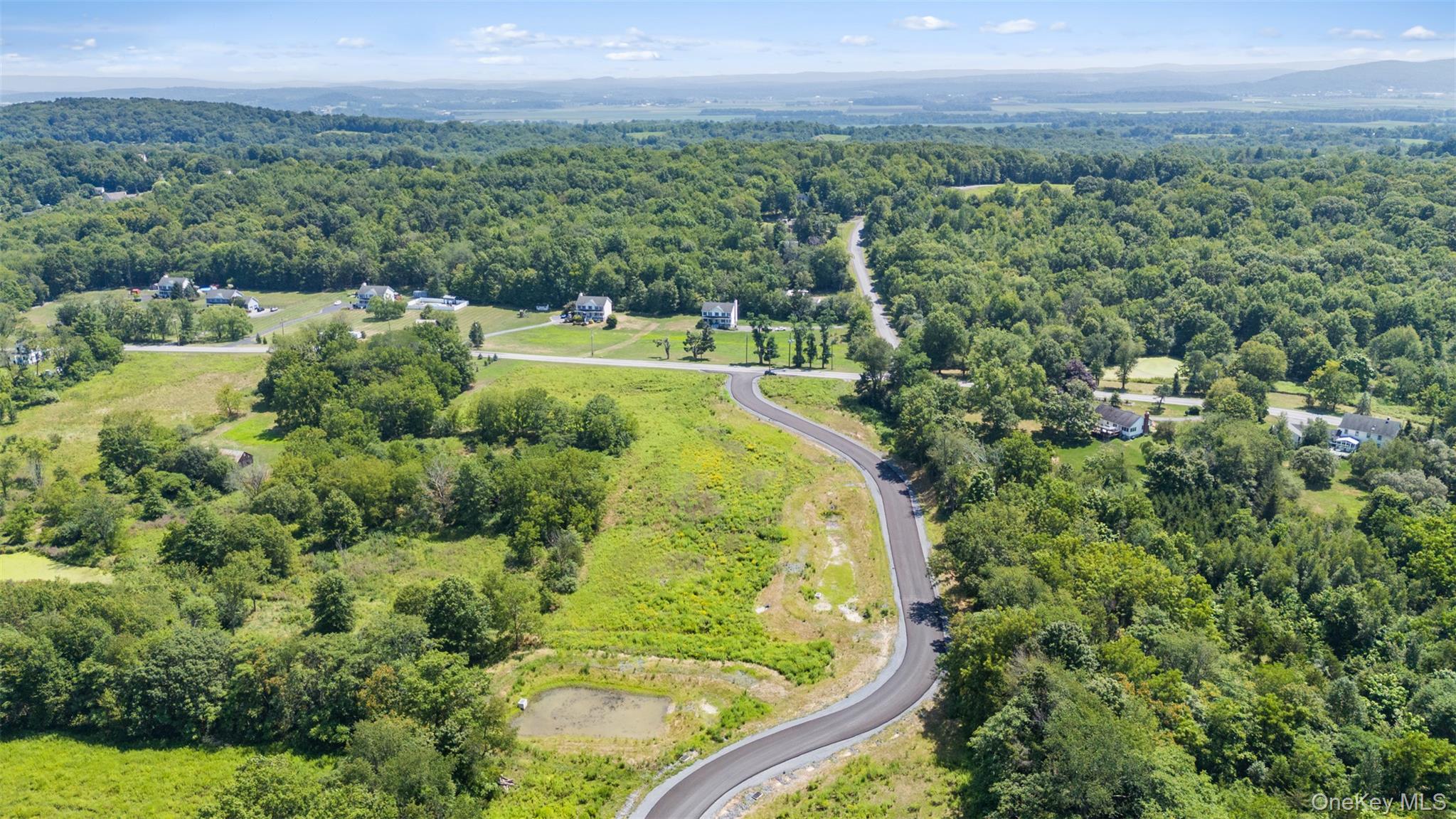 Lot #10 Azalea Lane Hopewell Junction, NY 12533 - Photo 14 of 15 a view of a garden with a building in the background