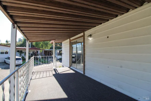 a view of a livingroom with wooden floor and a fireplace