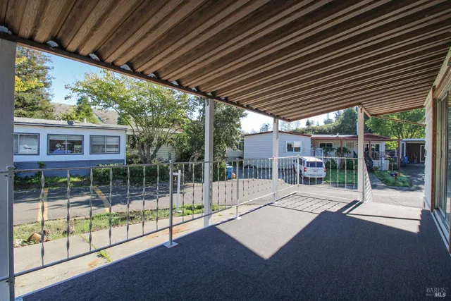 a view of empty room with a fireplace and windows