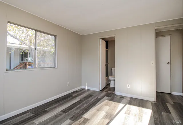 a view of a utility room with closet and mirror