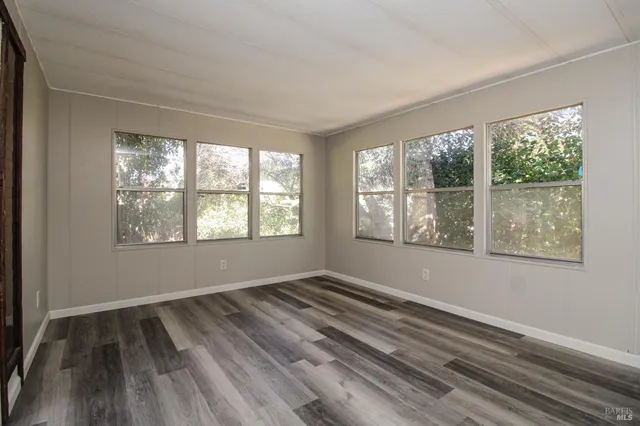 a kitchen with a sink cabinets stainless steel appliances and a window